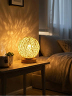 Woven table lamp on a wooden side table with a cozy living room setting.