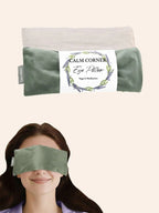 Green eye pillow with a label on a white background, used by a person.