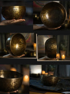 Hand holding a hammered brass singing bowl in a dim room with candles and soft background lighting