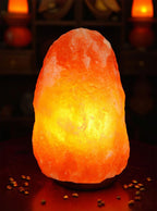 Himalayan salt lamp emitting a warm glow on a dark background