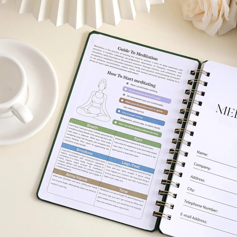 Meditation guide book open on a table with a cup and flowers in the background