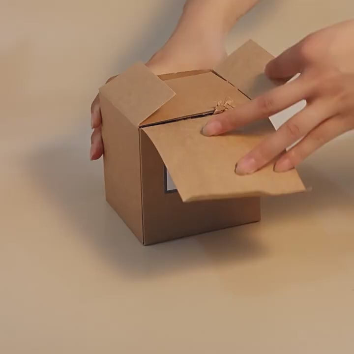 26-second unboxing video of coconut shell aromatherapy soy wax candle – opening cardboard box, unwrapping packaging, displaying 100% natural coconut shell jar, lighting with match, and showcasing warm flame glow (paired with calming instrumental music)